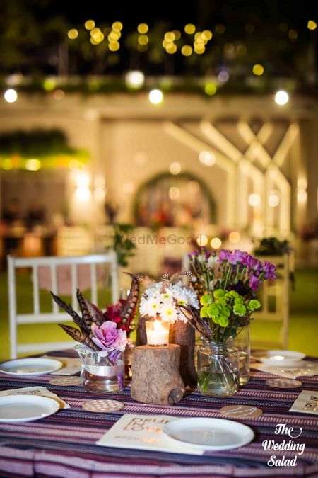 Table setting with flowers in glass jars and candles
