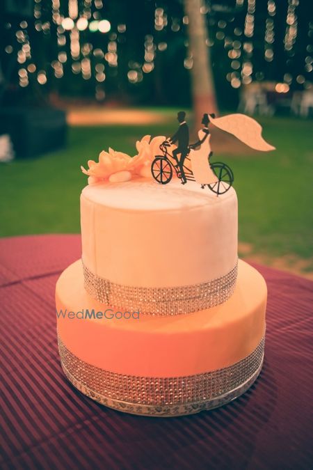 Peach wedding cake with a cute topper