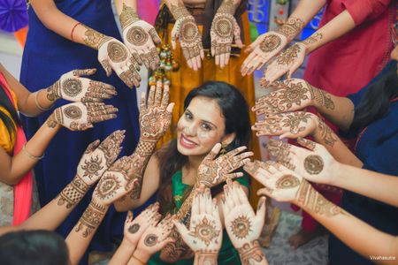 Bride and bridesmaids showing off mehendi