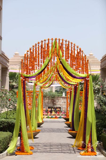 Photo of Entrance decor with hanging floral strings and colorful drapes