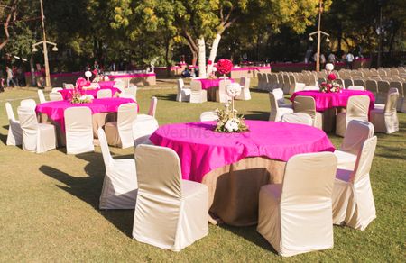 pink tables with white chairs