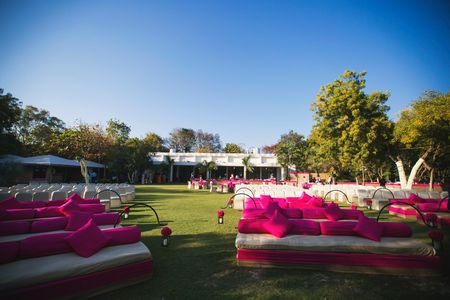 white and pink sofas with bright pink cushions