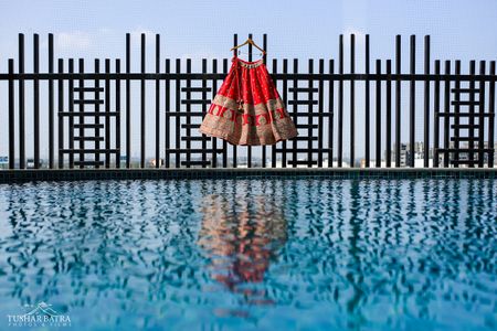 A beautiful red bridal lehenga captured moments before the bride donned it on her wedding day.