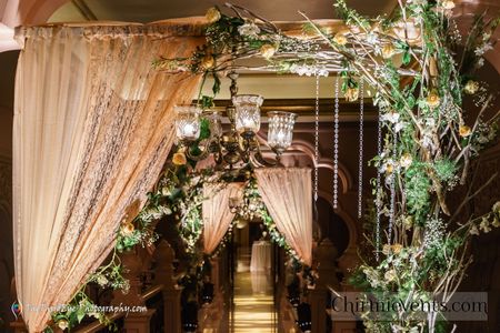 Photo of Indoor entrance decor with peach drapes and floral arrangements