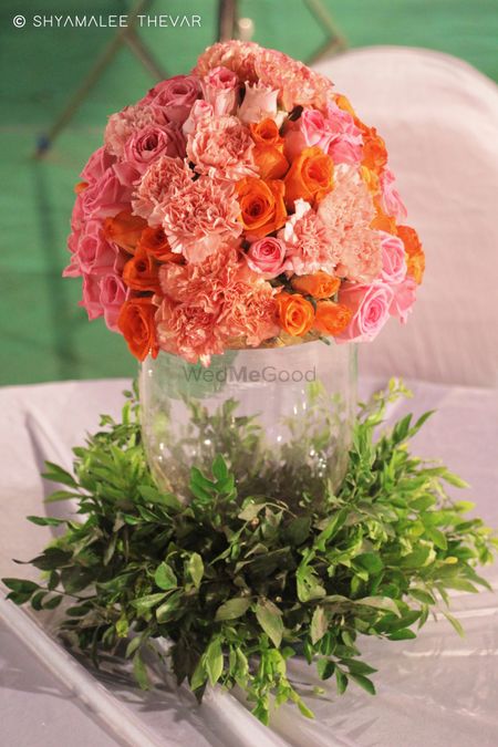 Floral centrepiece with peach flowers in mason jar