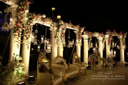 Elegant stage decor with flowers and candle lit chandeliers