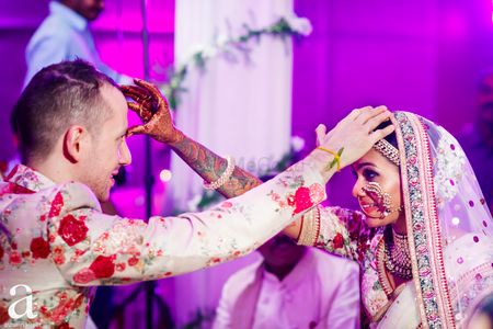 Beautiful candid couple shot while doing wedding rituals