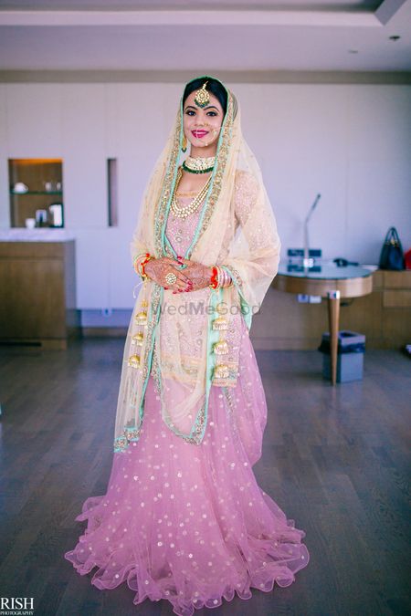 Sikh bride in pastel pink lehenga with light blue border
