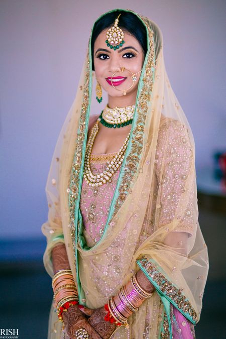 Sikh bride in pastel lehenga and contrasting jewellery