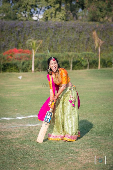 Bride playing cricket on mehendi