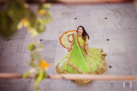 Photo of Bride twirling in pretty green lehenga
