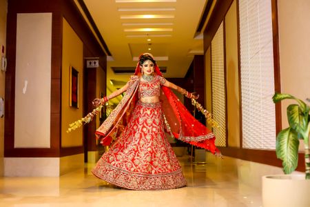 Twirling bride in red and gold