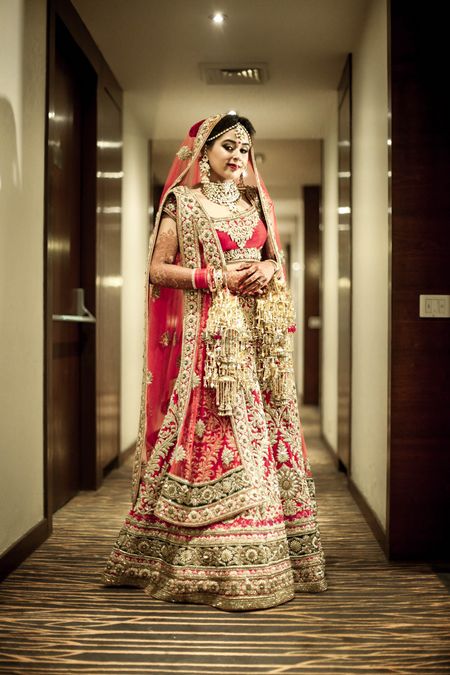 Classic red and gold bridal lehenga with heavy gold work and detailings