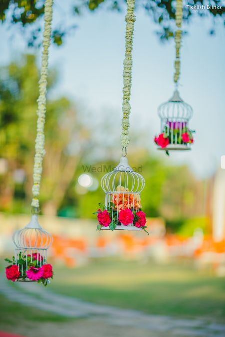Photo of Hanging birdcage with floral arrangement