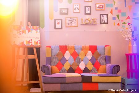 Photo of Sangeet photobooth idea with pop art theme and sofa