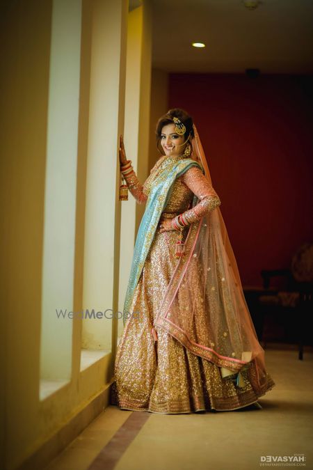 Rose gold sabysachi lehenga with baby blue dupatta