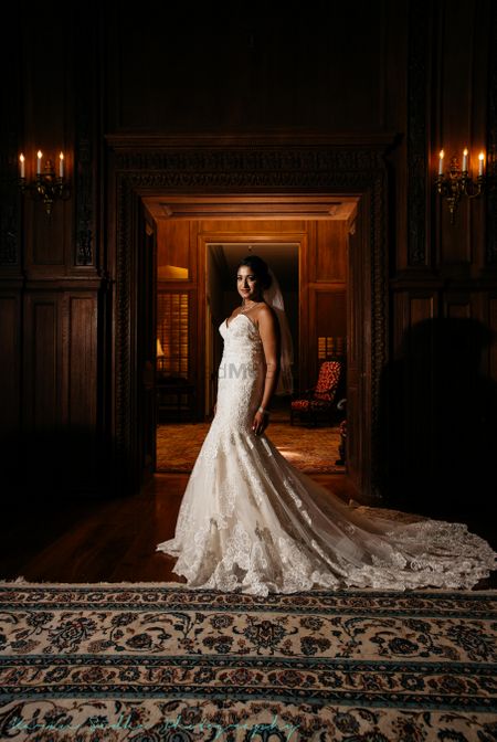 White christian wedding gown with trail and lace detailings