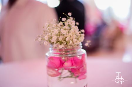 Flowers in glass jars as table centerpiece