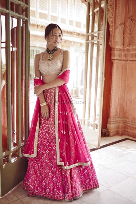 Pink lehenga with contrasting gold blouse Anita dongre