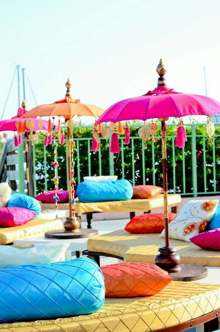 Mehendi seating idea with umbrellas with tassels