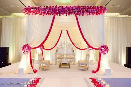 Indoor mandap decor in pink and white with drapes