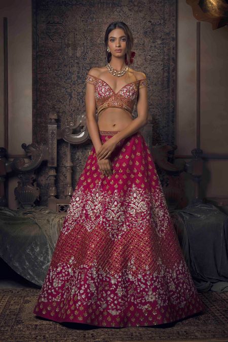Bright pink and gold lehenga with off shoulder blouse