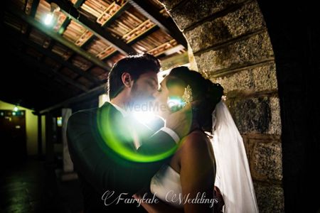 Couple kissing portrait with lens flare