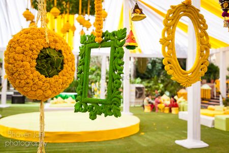 Hanging yellow and green frames as photobooth for mehendi