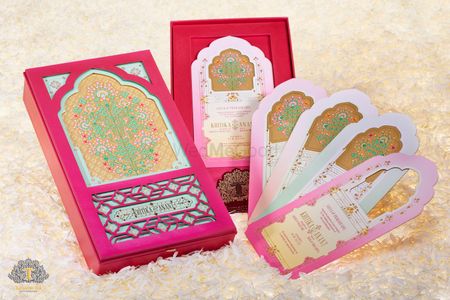 Photo of Beautiful turquoise and bright pink wedding invitation box with cards