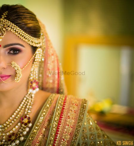 Photo of Half face bridal portrait with pearl Nath