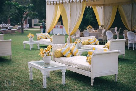 Photo of Yellow and white classy mehendi decor with unique tents