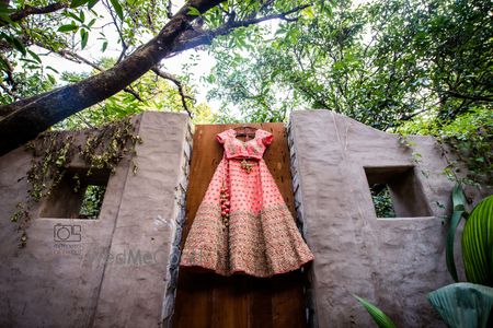 Light pink lehenga on hanger on gate