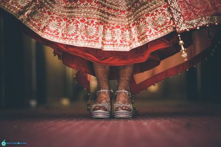 Silver bridal shoes with red lehenga