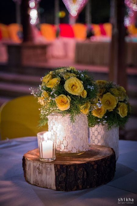 Photo of Mason jar with lace and flowers as centrepiece