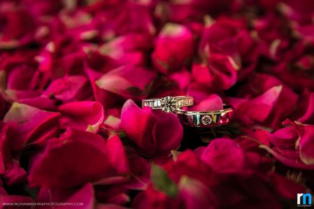 Couple Diamond Engagement Rings on Rose Petals