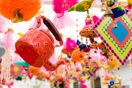 Quirky mehendi decor with hanging kettles