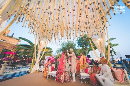 Mandap with hanging floral strings in neutral theme