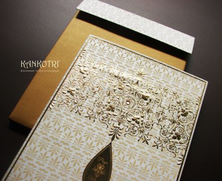 Photo of white and gold invitations