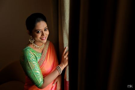 Photo of South Indian bridal look with pista green blouse and coral blouse