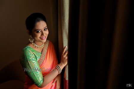 Photo of South Indian bridal look with pista green blouse and coral blouse