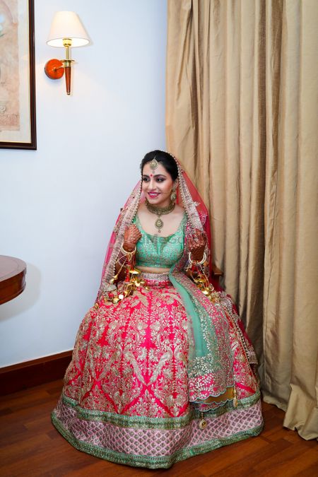 Offbeat bridal lehenga with turquoise blouse and pink skirt