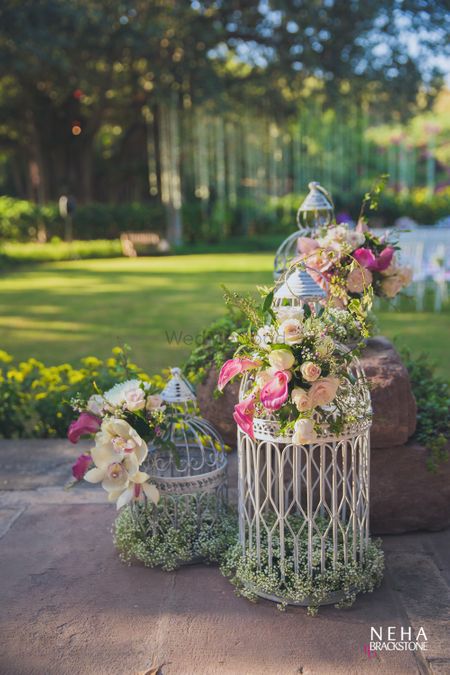 Photo of White floral birdcages in day decor