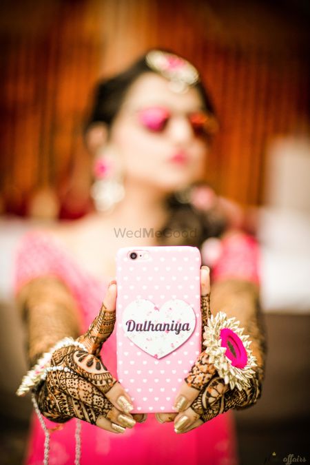 Bride holding up bridal dulhaniya phone cover