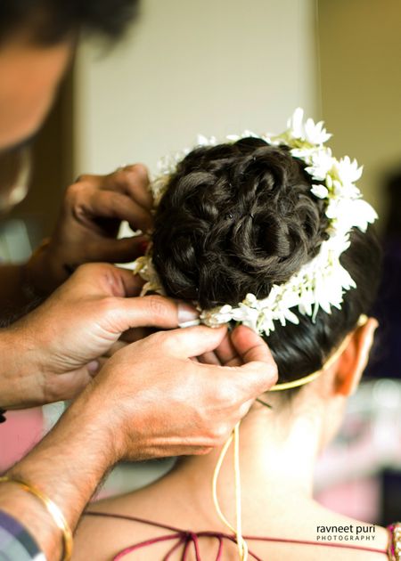 Bridal bun with braid and white flowers