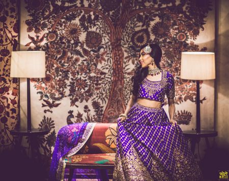 Bride in purple sangeet lehenga posing