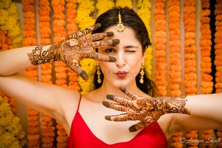 Photo of Bride showing off mehendi on both hands