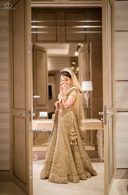 Bride in gold lehenga shot