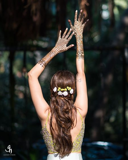 Bride to be showing off mehendi in a unique pose