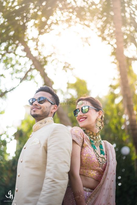 Photo of Cute couple shot with bride and groom in sunnies