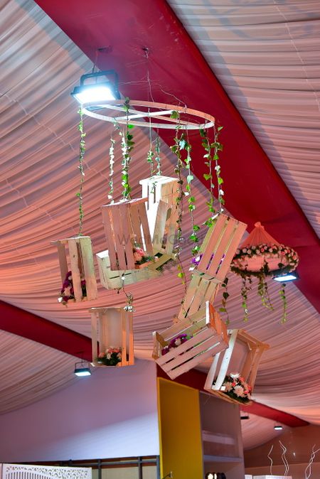 Chandelier with hanging wooden crates and florals
